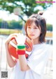 A young woman holding a basketball in her hands.