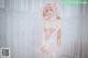A woman in a white lingerie posing for a picture.