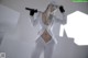 A woman in a white outfit holding a sword.