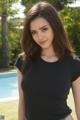 A woman in a black shirt posing by a pool.